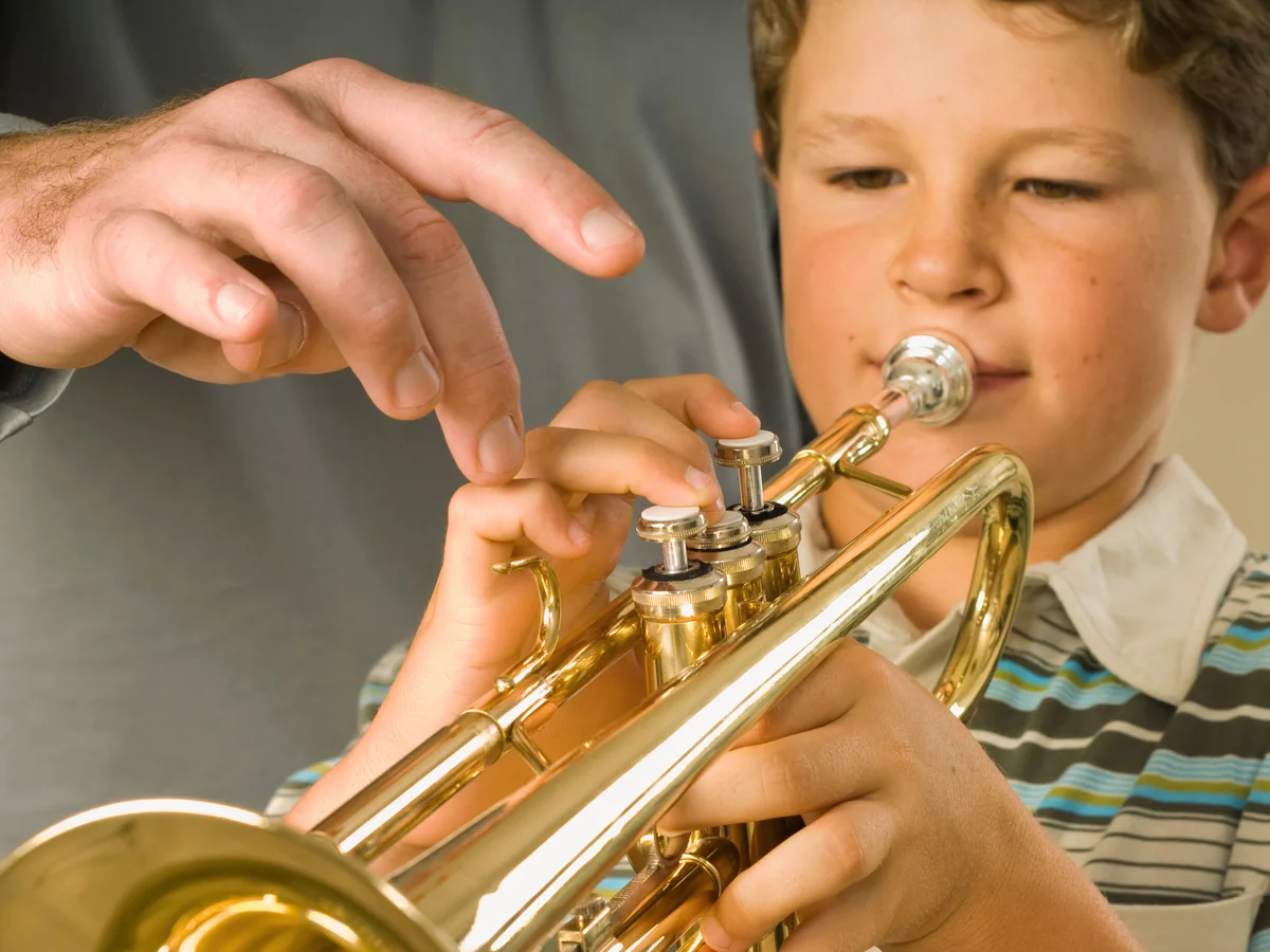 A Rīgas Privātā Mūzikas Skola musician playing brass live on stage in Riga