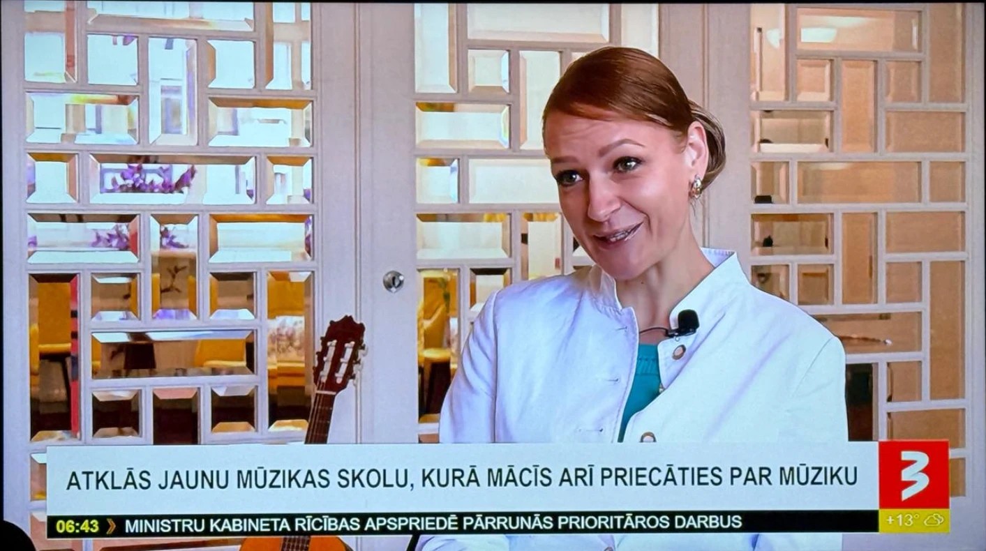 Linda Boida, co-founder of Rīgas Privātā Mūzikas Skola, on TV3's "900 sekundes", with the on-screen caption "A new music school opens, which also teaches people to enjoy music"